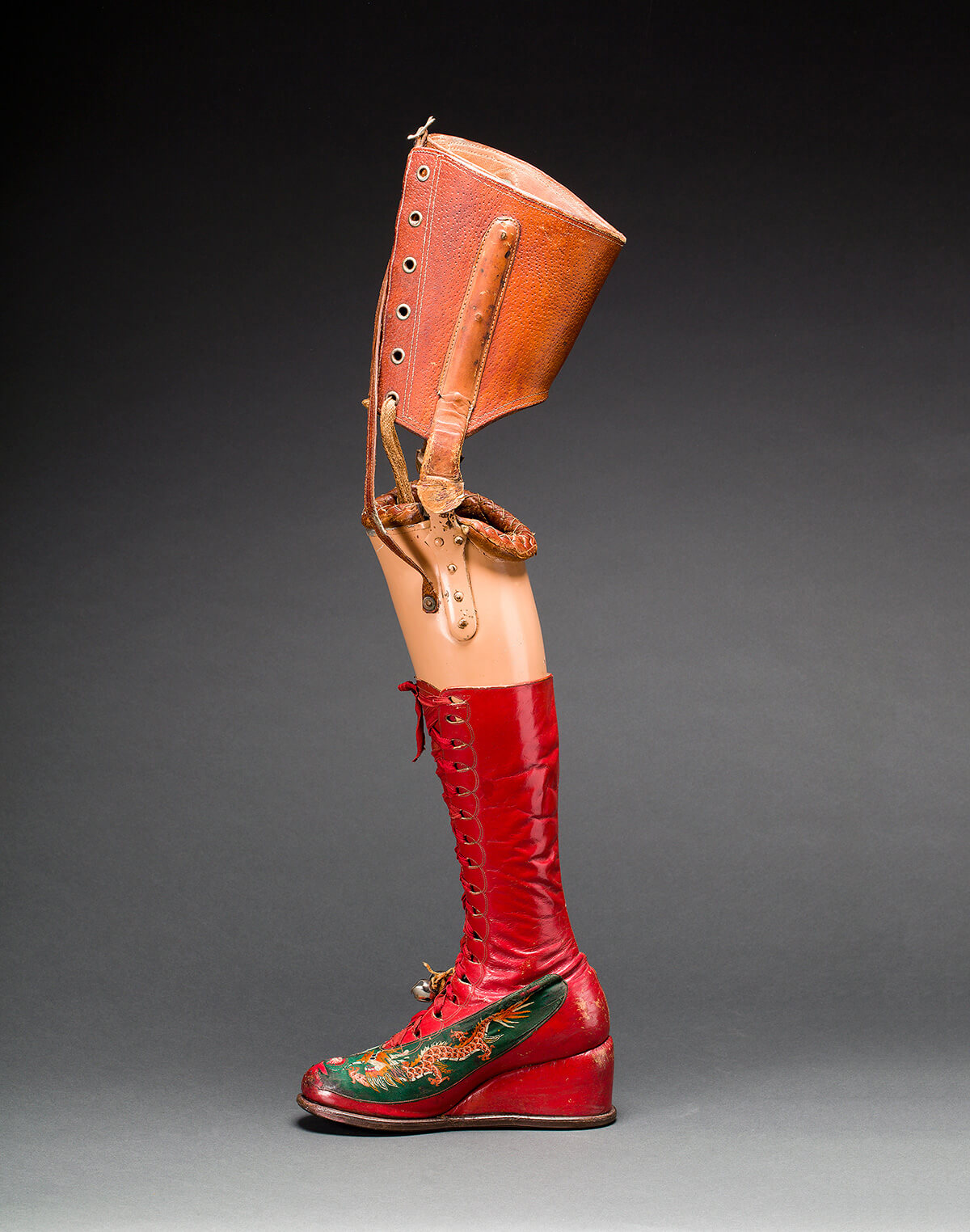 Frida Kahlo's prosthetic leg with leather boot. Appliqued silk with embroidered Chinese motifs. Photograph Javier Hinojosa. Museo Frida Kahlo. © Diego Riviera and Frida Kahlo Archives, Banco de Mexico, Fiduciary of the Trust of the Diego Riviera and Frida Kahlo Museums.